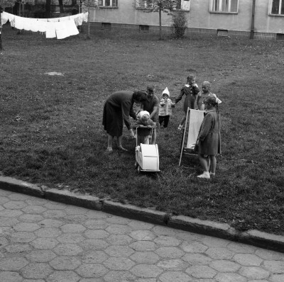 Kobieta z dziećmi i suszące się pranie na podwórku przed blokiem przy ul. Żwirki i Wigury w Rzeszowie