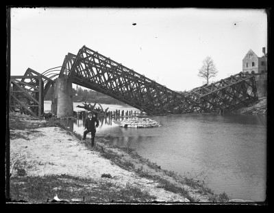 Mężczyzna na tle wysadzonego przez Rosjan mostu kolejowego na Wisłoku w Rzeszowie 11.05.1915 r.